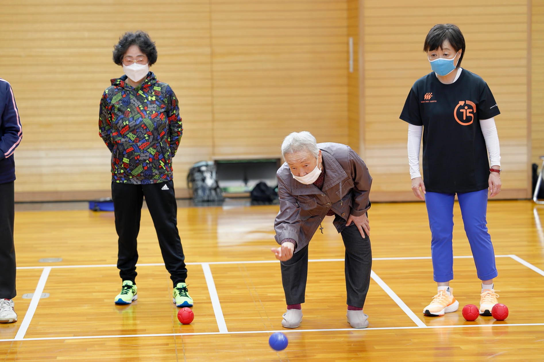 The woman playing boccia next to Masuda.